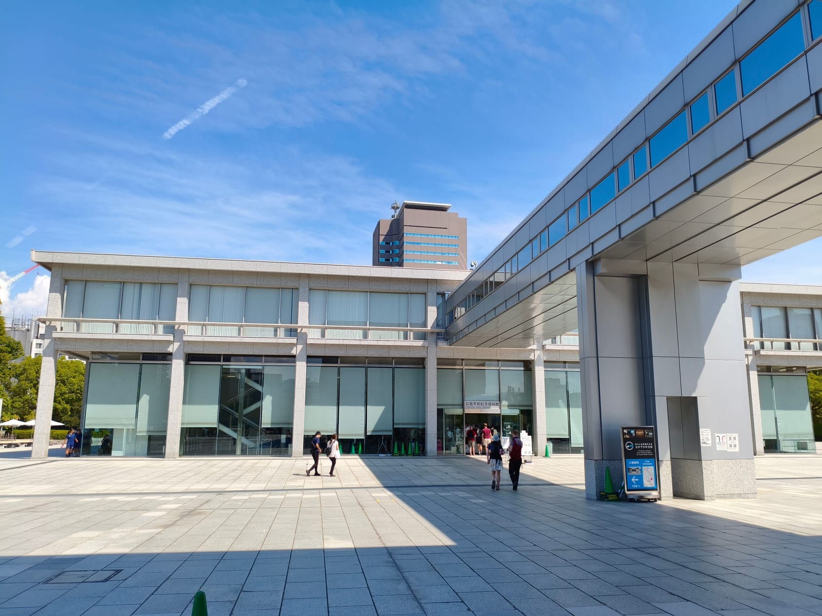 The long low modern building of the Hiroshima Peace Memorial Museum seen across an open plaza