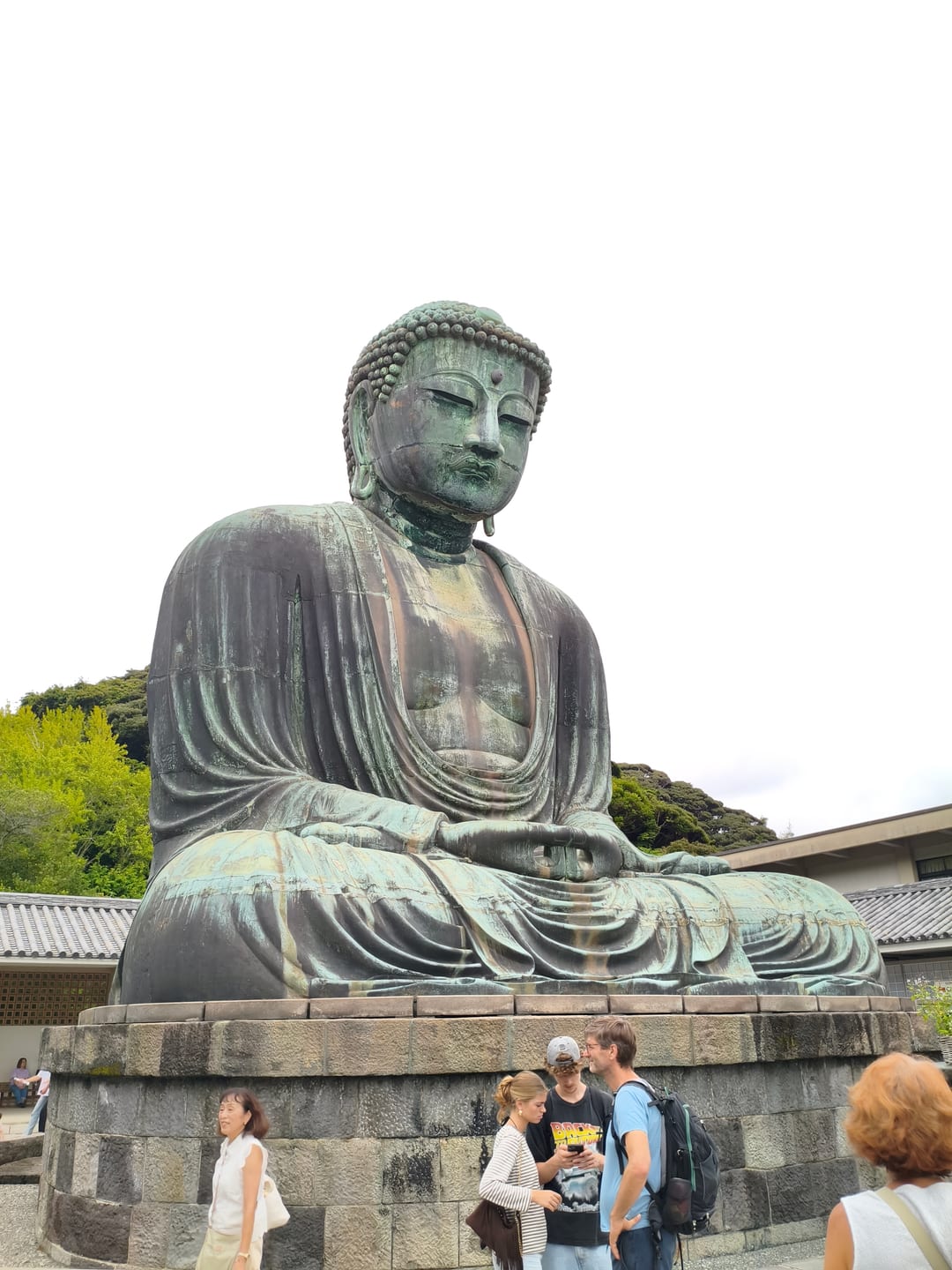 The Great Buddha of Kamakura, a large bronze seated figure on a stone base