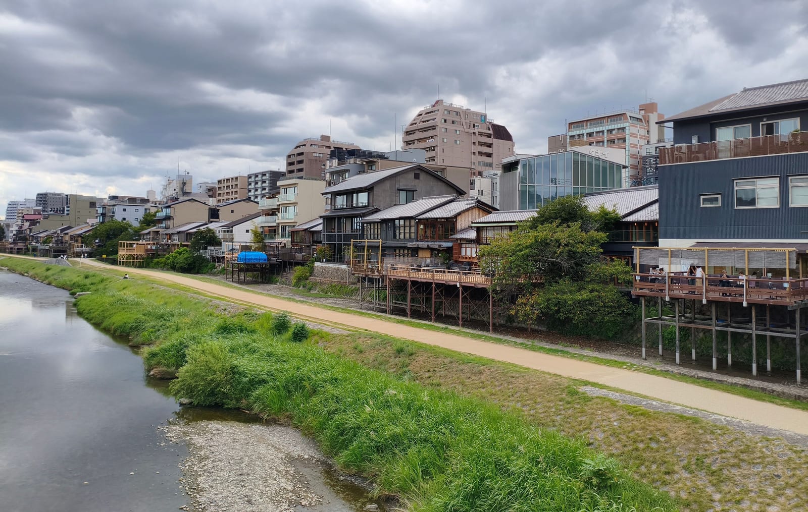 The Kamo River with wooden dining terraces built out on stilts above the bank