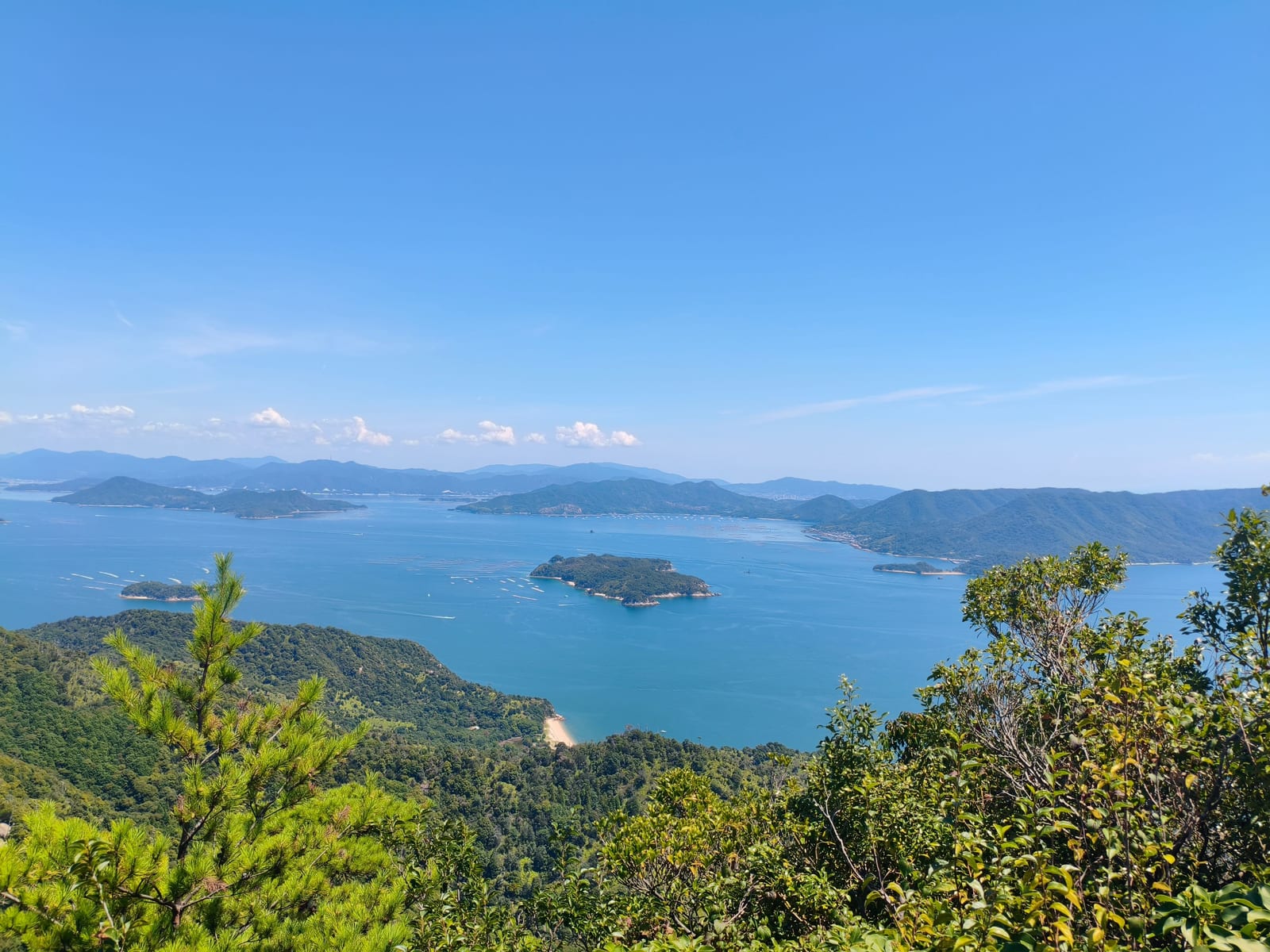 The islands of the Seto Inland Sea seen from high on the mountain, blue water and haze to the horizon