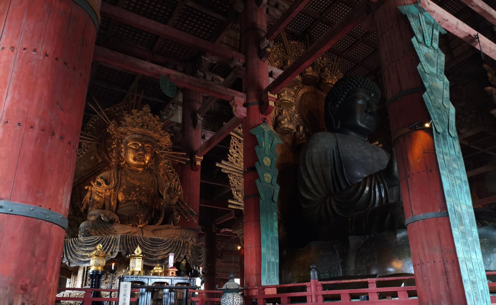 The bronze Great Buddha of Todai-ji seated inside the hall, with a gilded bodhisattva statue to its left