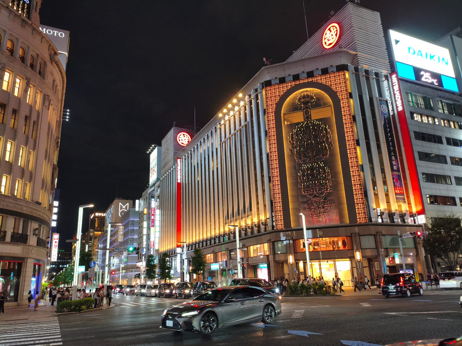 A Ginza crossing at night, an illuminated department store facade above the street